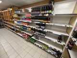 many shelves in the store that are filled with drinks