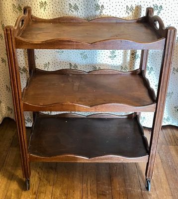 a wooden shelf with three shelves on top of it