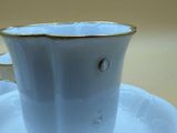 a cup and saucer sitting on a saucer on a table