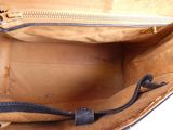 a brown bag with a zipper on the inside of it