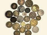a lot of coins that are on a white surface