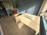 an image of a room with a desk and a bookcase