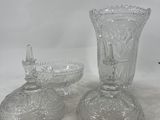 two clear glass vases sitting next to each other on a table