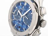 a close up of a watch with a blue strap