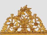 a gold clock on a stand on a white background