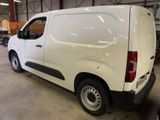 a white van parked in a garage with other vehicles