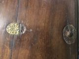 a close up of a wooden table with a knob on it