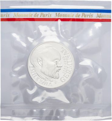 a close up of a coin in a plastic bag on a white background