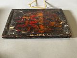 an old wooden tray with a metal handle on a table