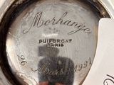 a silver plate that has a tag on it