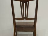 a wooden chair that has a star on the back of it