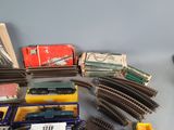 a lot of toy trains on a table with boxes
