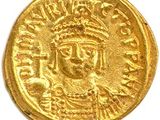une pièce d'or à l'effigie d'un homme coiffé d'une couronne