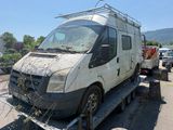 a white van that is sitting on a flatbed