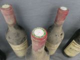 several bottles of wine sitting next to each other on a table