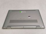 a silver laptop with a green sticker on it