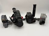 many different cameras that are sitting on a white surface