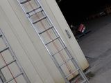 two ladders leaning against the wall of a building