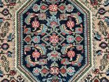 an antique persian rug with a blue and red design