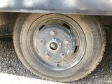 a flat tire on a flatbed truck parked on the side of the road