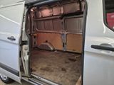 a white van with its door open in a garage