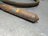 a metal pipe and a hose on a table
