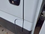 a close up of a white truck with a black door handle