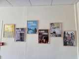 a lot of posters on the wall of a restaurant