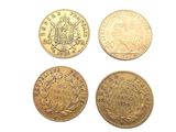 four different types of gold coins on a white surface