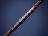 a gold, diamond and ruby bar broochle on a blue background