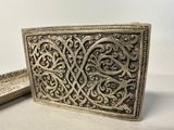 an old silver belt buckle with a decorative design on it