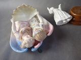 a small doll in a shell with a doll in it