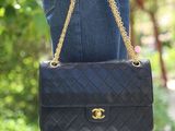 woman holding a black chanel bag in her right hand