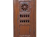 an image of a wooden cabinet with a wine rack on top of it
