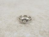 a close up of a diamond ring sitting on a table