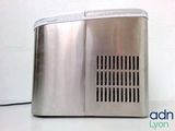 a silver toaster sitting on a table with a white wall in the background