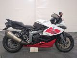 motorcycle parked in a garage with a checkered floor and white walls