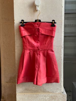red dress hanging on a wall in front of a building