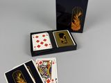 a set of four playing cards and a box of playing cards