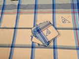 a blue and white checkered table cloth with a monogram