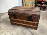 an old trunk that is sitting on the ground