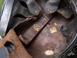 a close up of a helmet with a leather strap