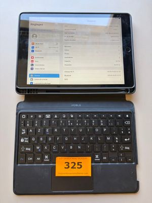 a tablet computer sitting next to a laptop computer on a table