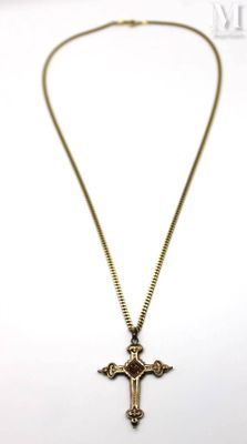 a close up of a necklace with a cross on it