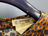 a brown and black leopard print bag with a tag on it