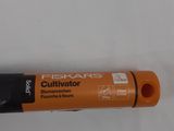 an orange pen with a black tip sitting on top of a white surface