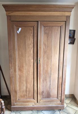 a large wooden cabinet in the corner of a room
