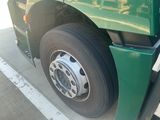 a green truck that is parked on the side of the road