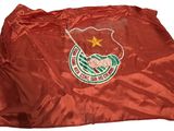 a red bag with a flag on it sitting on top of a table