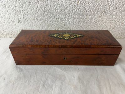 an old wooden box with a decorative design on the lid